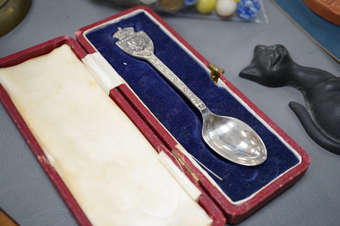 Sundry items to include a silver commemorative spoon, collection of marbles, brass candlestick and a souvenir treen ruler